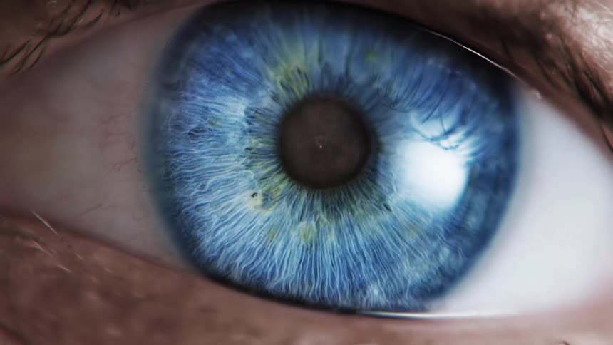 Macro shot of a bright light reflecting from a blue eyeball