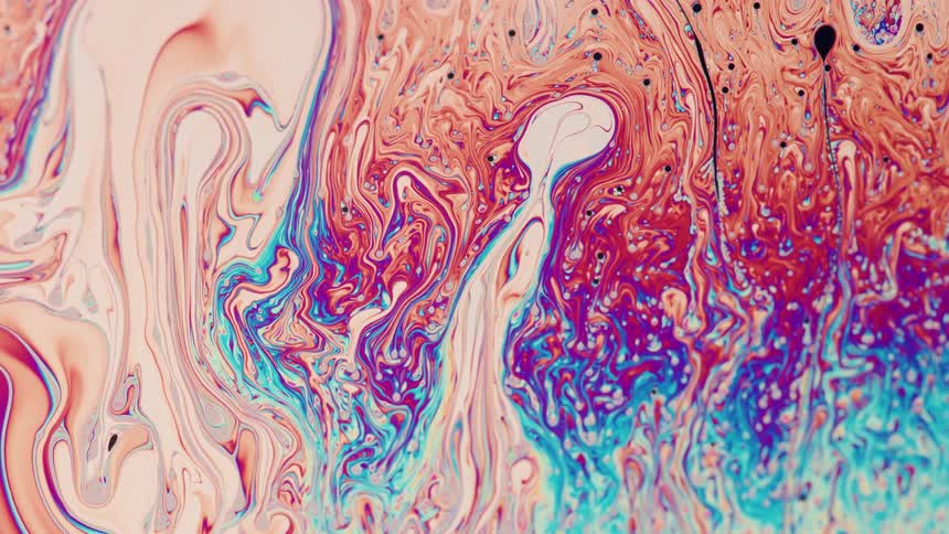 A flow of moving liquid like paint with blue red and pink color mixing together