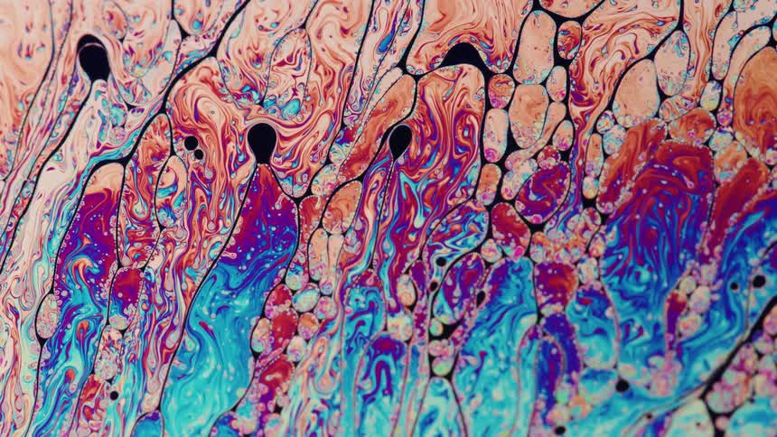 A colorful liquid with different geometric shapes moving around