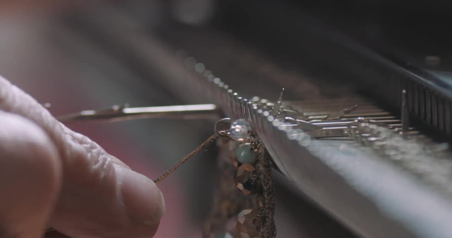 A person is making jewelry