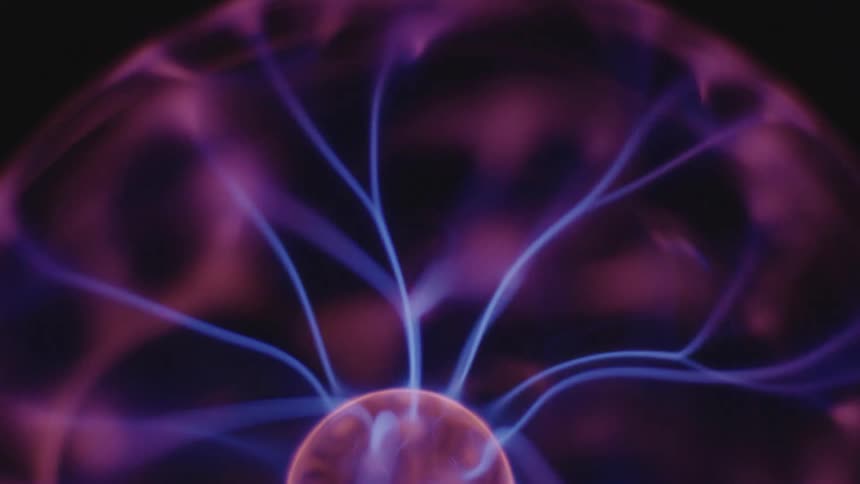 Glowing blue threads of electricity stretch as they move from a pink sphere and illuminate the inside of the orb