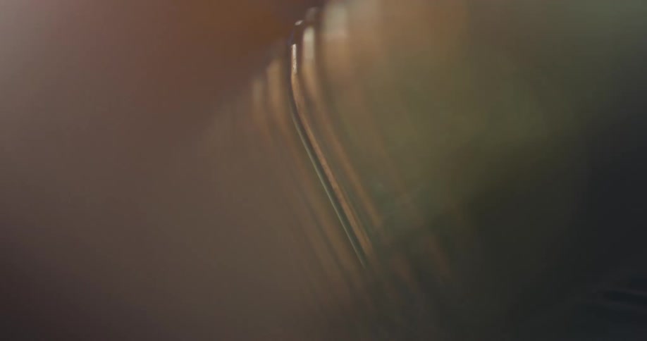 Close up of a person threading a thread on a metallic tool
