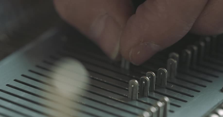 A man fingers moving an amplifying switch up and down