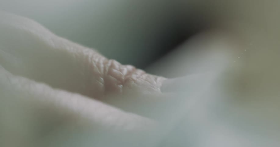 Close up of a seamstress sewing clothing with a hook