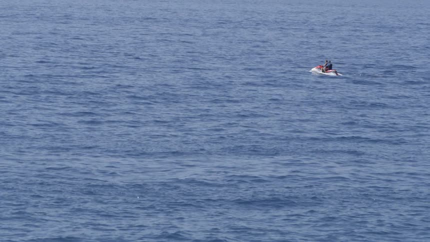 People are on a jet ski in the water