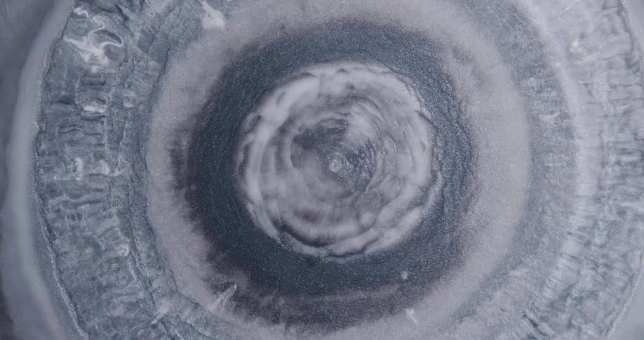 A big hole with gray liquid