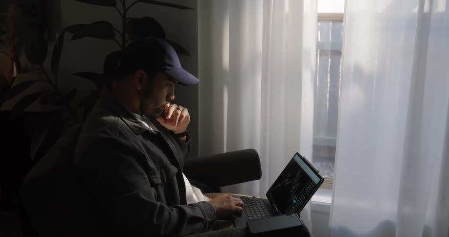 A man is looking at his laptop