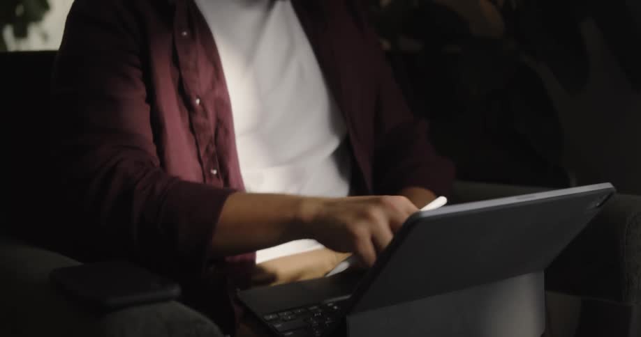 A man is typing on his laptop