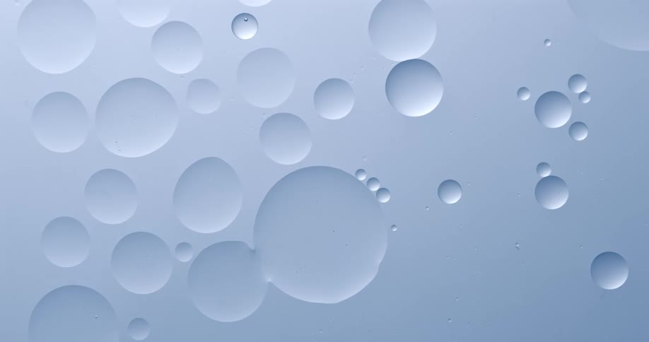 Orbs are floating in a white substance and they merge into one as they touch