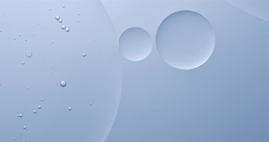 Orbs floating in a white environment bump and touch as they connect and become larger