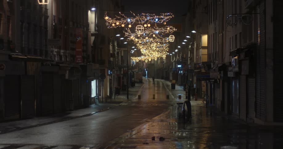City street at night decorated with flickering lights