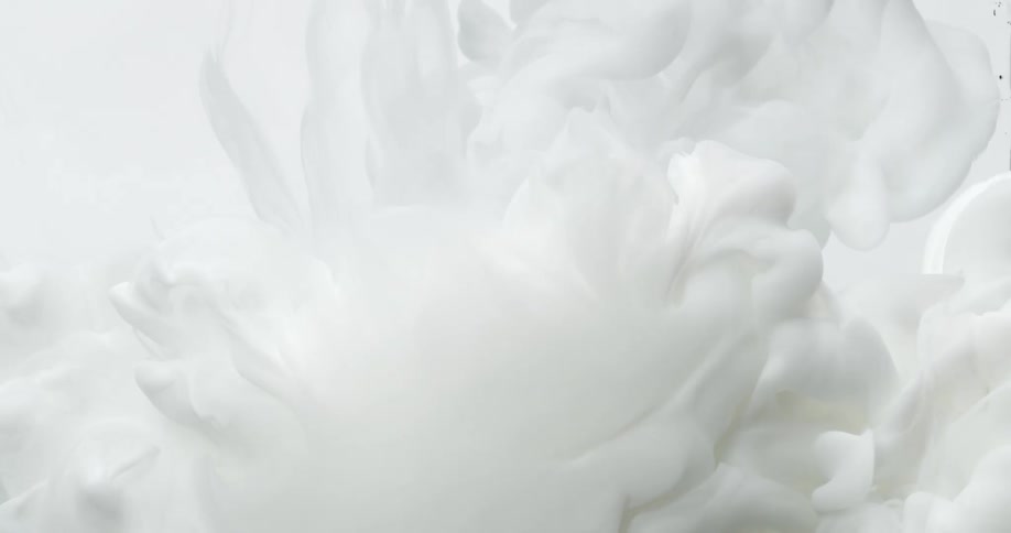 Cloud of white floats and expands through liquid