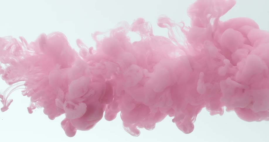 A thick pink cloud expands as it floats in a white environment