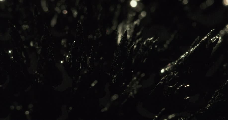 Light shines on long jagged pointed shards in the darkness