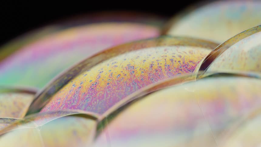 The group of bubbles is shifting with many different colors in them