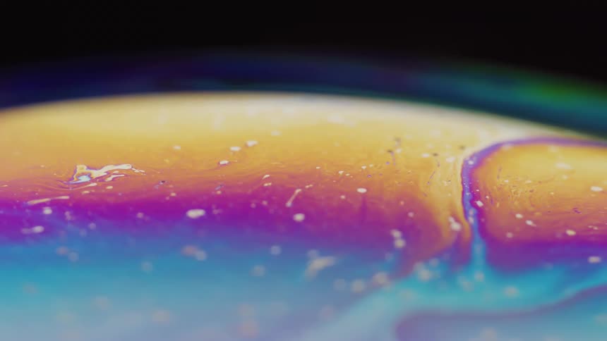 Close up of the bright colorful surface of a soap bubble
