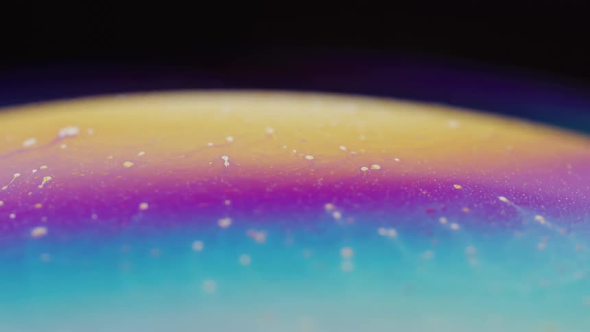 Thin blue atmosphere floats over surface of multicolored multilayered mixture contained in sphere