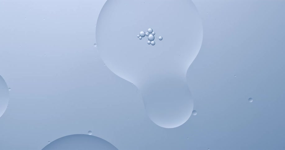 Bubbles on water floating and integrating themselves over a white surface