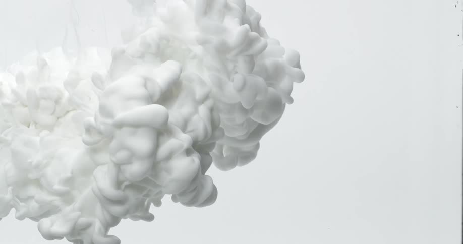 White paint moving slowly onto a white screen as it billows and fills the canvas
