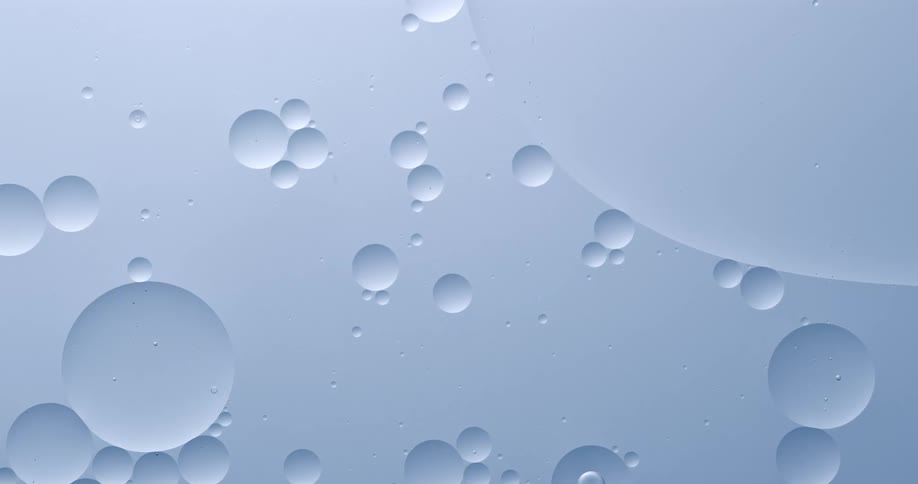 Small burbles on a blue surface merging to larger burbles