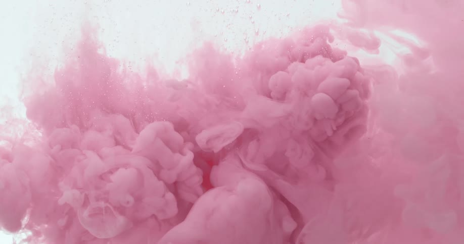 Pink dye expands through clear liquid creating bubbles