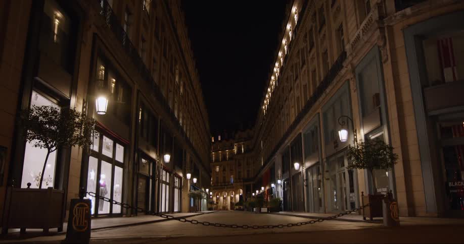 Stores on an empty street at night