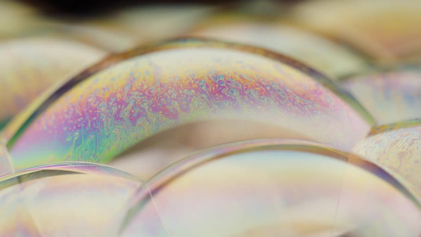 Neon colored fluid flowing inside receptacles circled by a metal ring