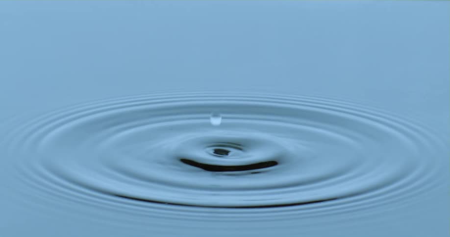 Water drops in a river at midday