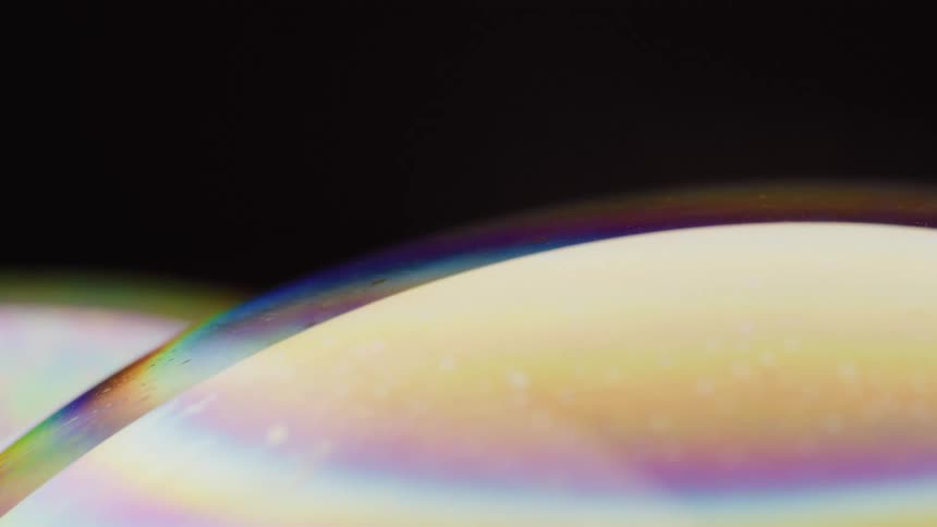 Multicolored multilayered mixture moves under rainbow film in sphere