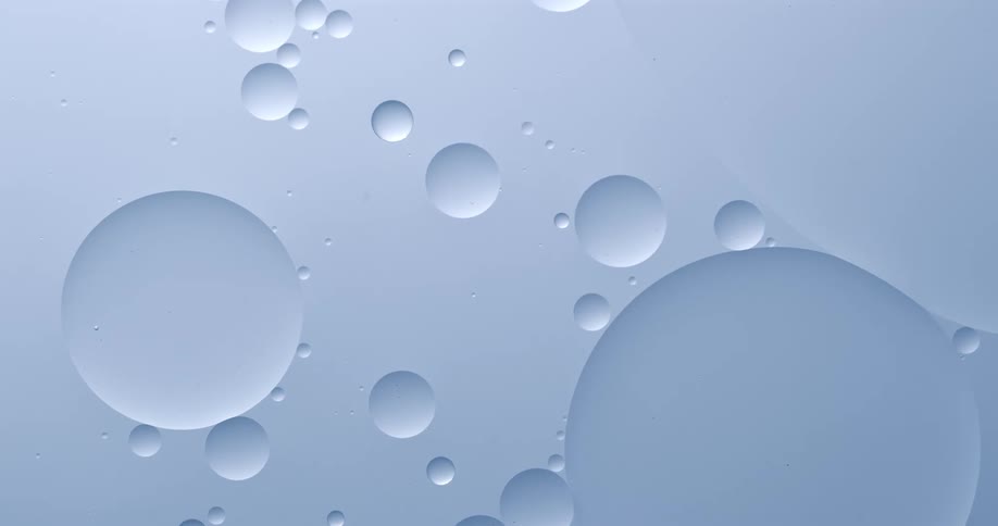 Various sized bubbles effortlessly drift through a clear liquid