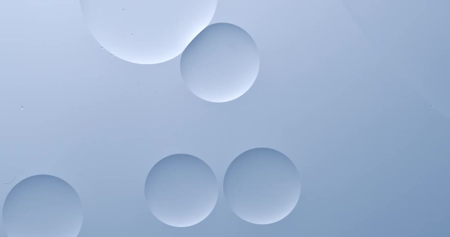 Five whitishblue circles move slowly and bounce off of each other