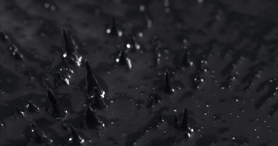 Spikes emerge from oily black liquid before collapsing