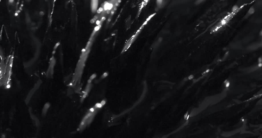 Spikes covered in dark oily substance going up and down