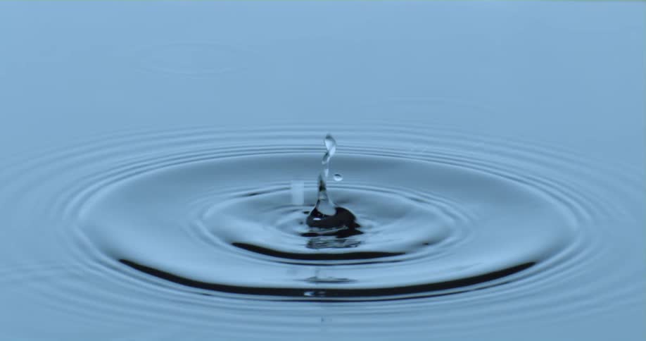 The drop falls and causes ripples