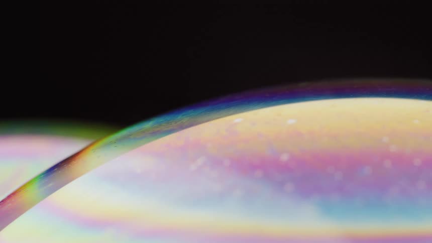 The rainbow of colors on the bubble are moving and swirling around