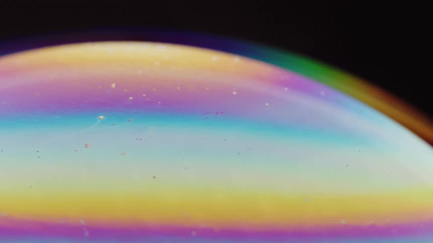 A planet is shown up close with a rainbow and pastel colors all over it