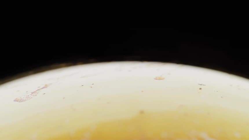 A yellow tinted sphere spins around
