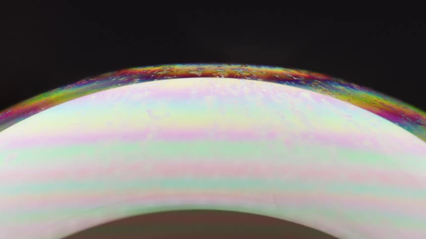 Rainbow colors appear at the edge of a lighted sphere