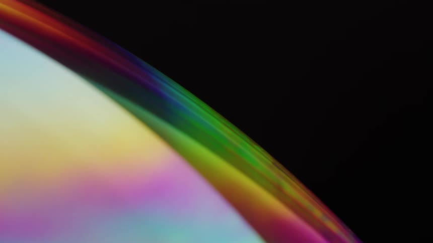 A sphere deep in space with rainbow color rotating slowly
