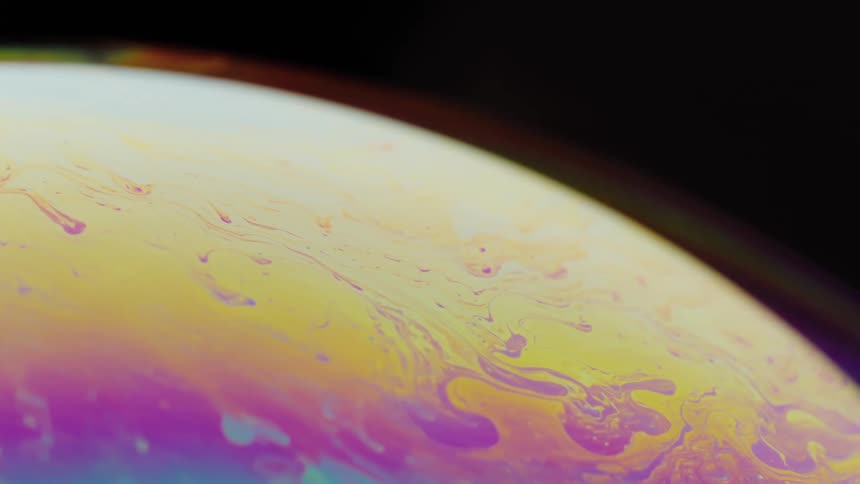 The rainbow of colors is spinning and swirling around the bubble
