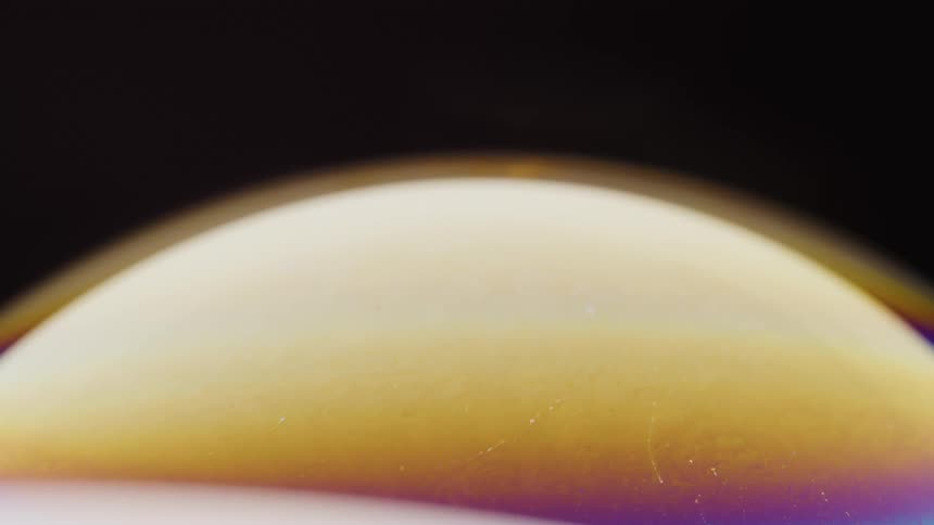 Multicolored multilayered mixture moves in bubble under film