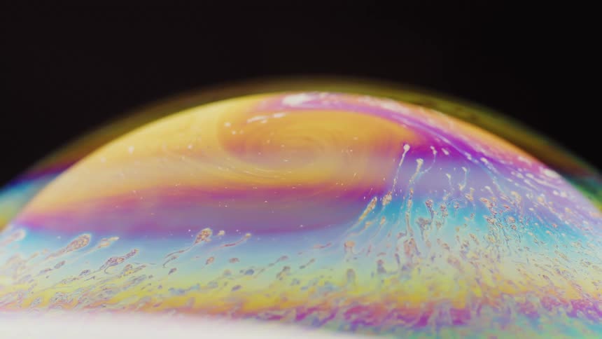 Close up of the bright colorful surface of a soap bubble
