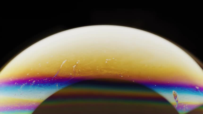 The rainbow of colors is flowing to the right on the large bubble that has a darkened center