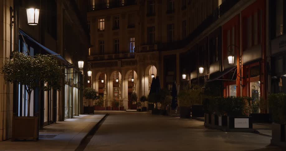 A quiet street with close buildings at night