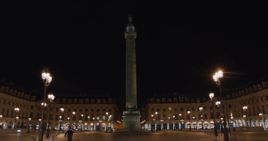View of a public square with a central pillar at night