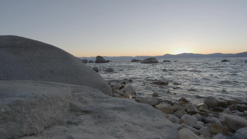 Many large and small rocks line this shore