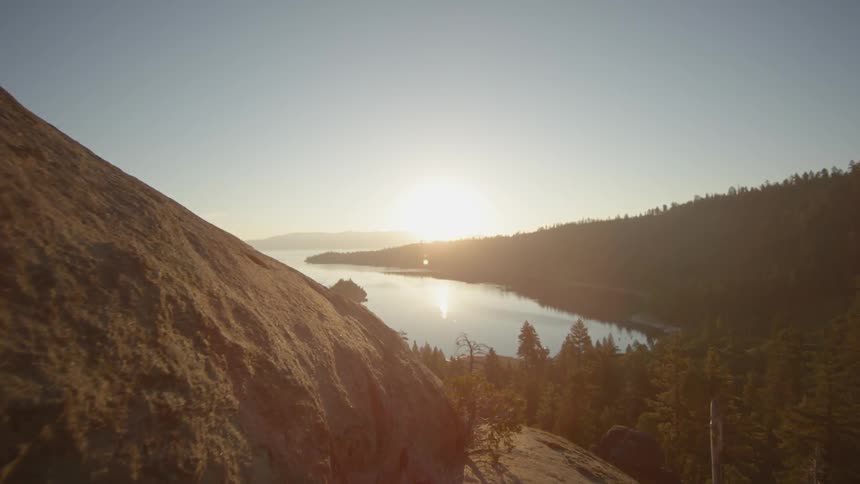 Moving over the top of a mountain with a lake ahead
