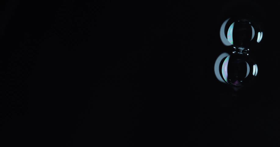 Two circular shapes attached together float through blackness