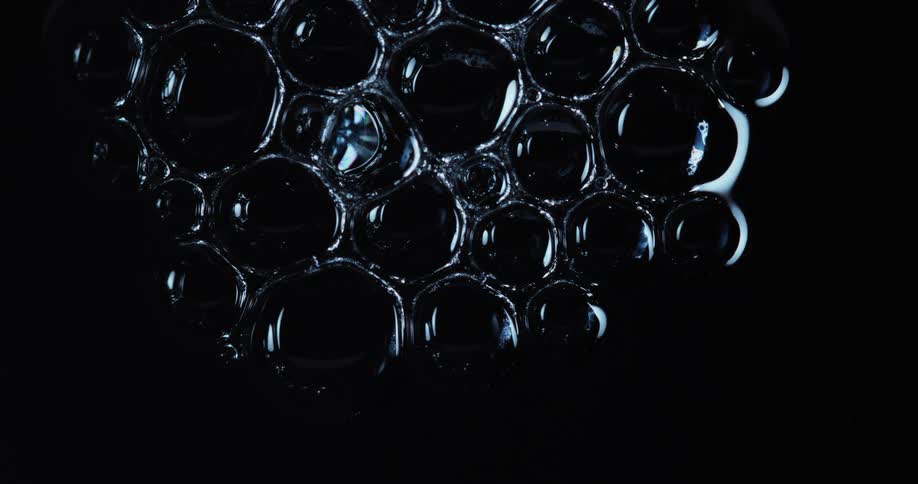 The bubbles begin to pop and combine in the dark
