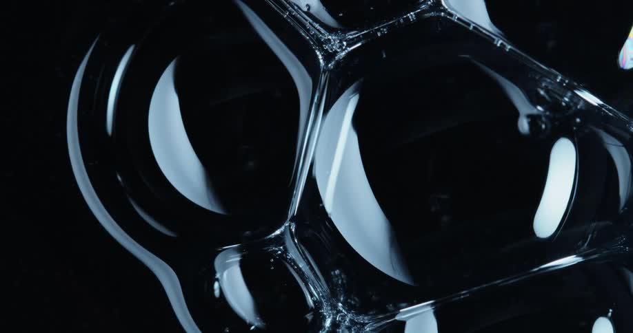 Several reflective dark bubbles joined together